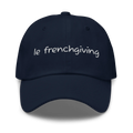 A navy blue baseball cap with 'le frenchgiving' embroidered in white script across the front, shown against a plain white background.