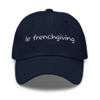 A navy blue baseball cap with 'le frenchgiving' embroidered in white script across the front, shown against a plain white background.