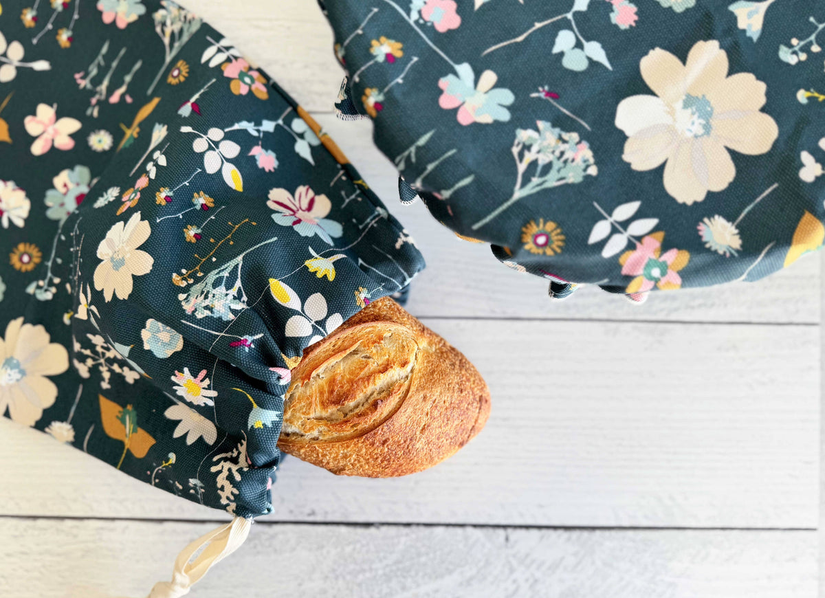 Floral-patterned fabric with a baguette on a wooden surface