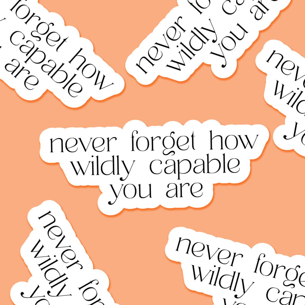 Motivational stickers with text 'never forget how wildly capable you are' on a peach background