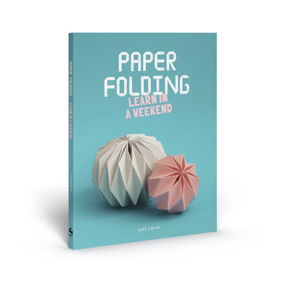 Book titled 'Paper Folding Learn in a Weekend' with origami models on a teal background