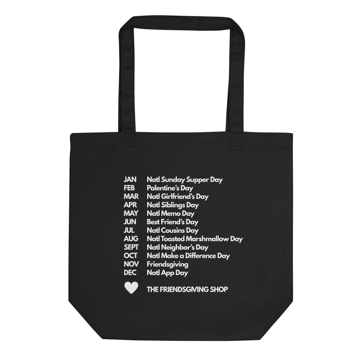A black canvas tote bag with two handles, featuring a white printed list of 'Noot' days around the calendar and the text 'THE FRIENDSGIVING SHOP' with a small heart at the bottom.