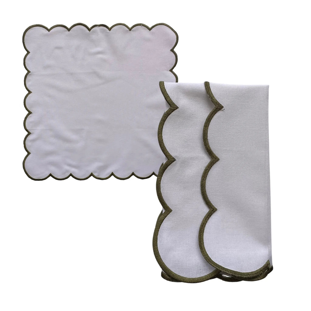 A set of white fabric cloths with scalloped edges, including one unfolded cloth and one folded cloth, both featuring a dark olive green trim, shown on a plain white background.