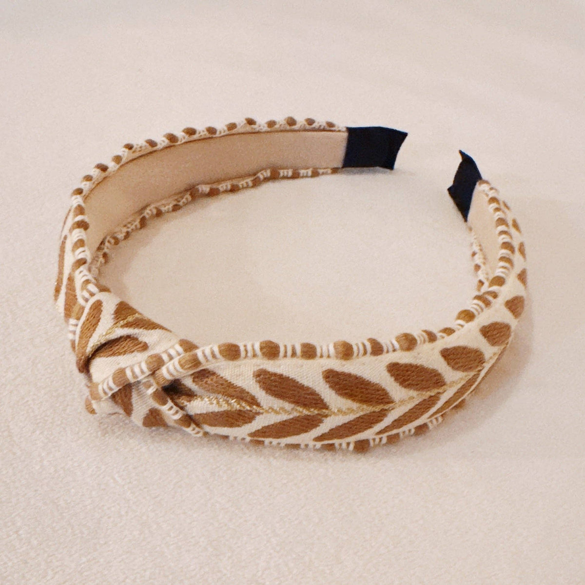 Patterned headband on a beige background