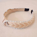 Beige headband with decorative elements on a beige background