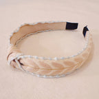 Beige headband with decorative elements on a beige background
