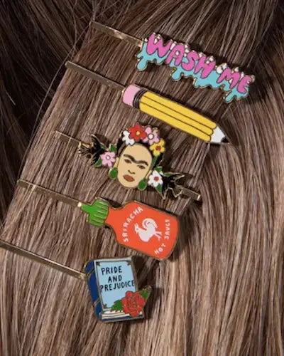 Collection of colorful pins on a textured surface