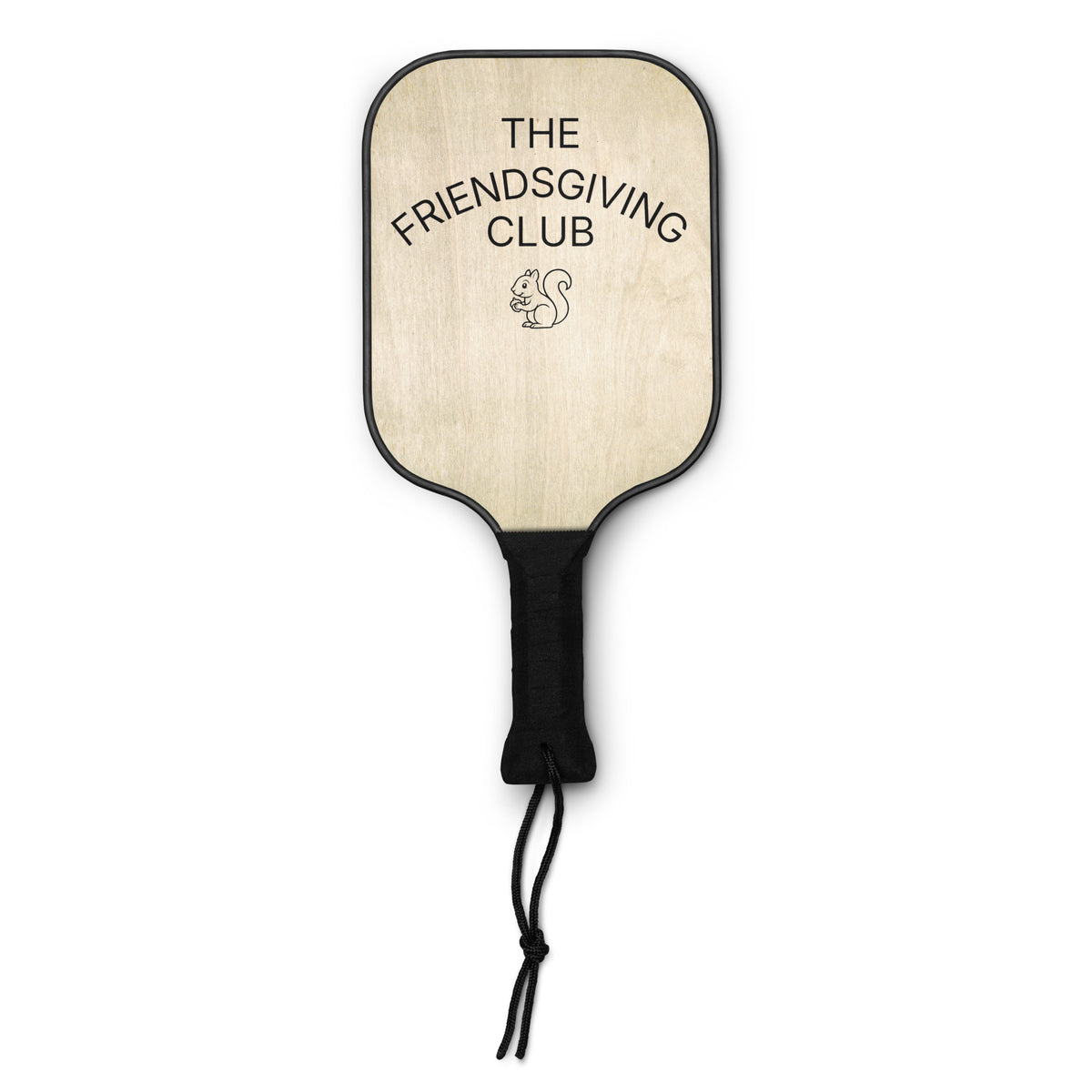 A paddle-style hand fan with a light natural wood face, black trim, a black wrapped handle, and a black cord. The face is printed with the text 'THE FRIENDSGIVING CLUB' and a small squirrel illustration.