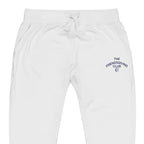 White sweatpants with a drawstring waist and a small navy blue graphic embroidered on the left thigh that reads 'THE FRIENDS GIVING CLUB'.
