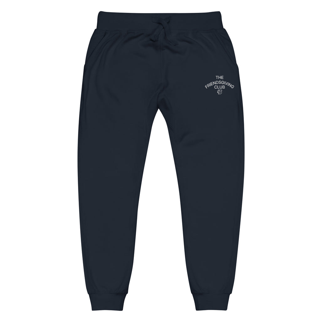 A pair of dark navy sweatpants with a drawstring waist and a small white embroidered logo on the upper right hip, displayed against a solid white background.