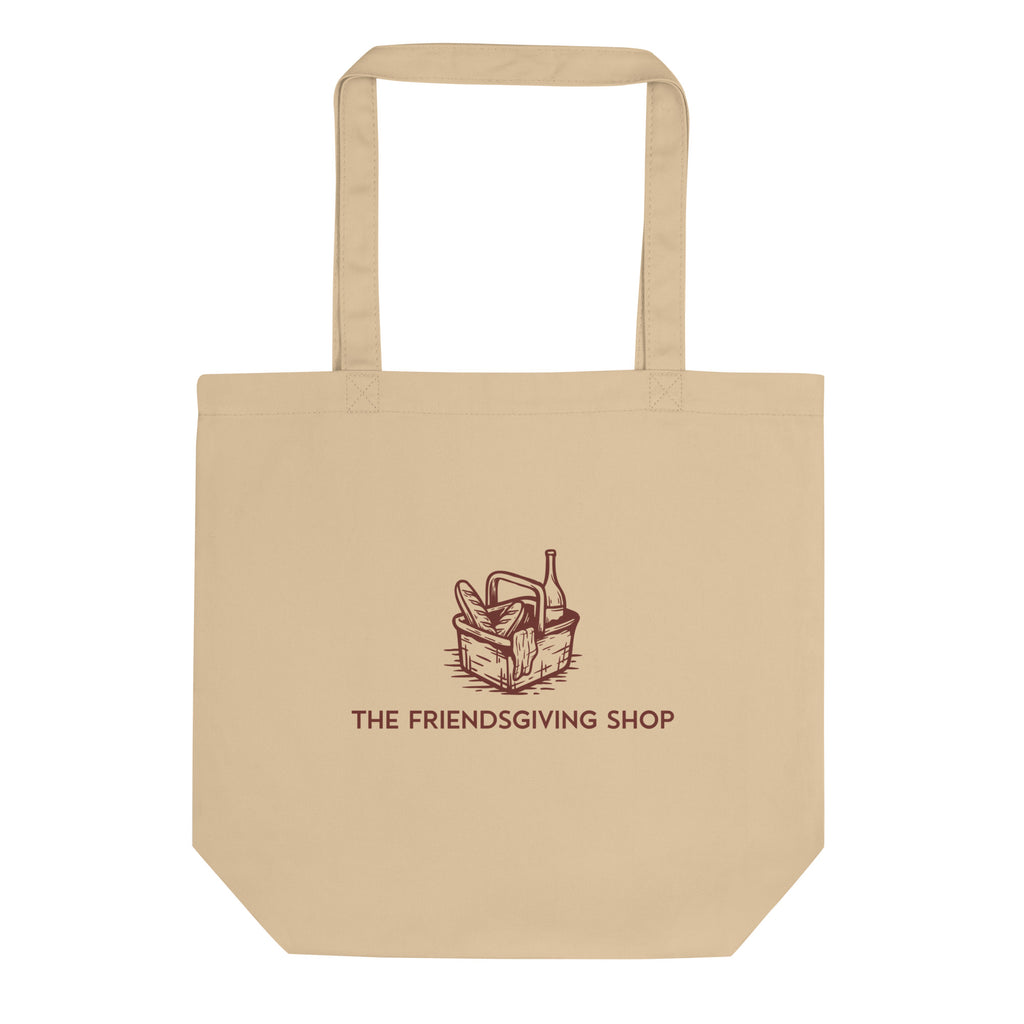 Beige tote bag with 'The Friendsgiving Shop' logo on a white background