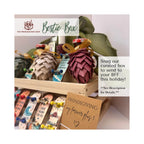 A curated 'Bestie Box' friendship gift set displayed on a wooden shelf, featuring handmade paper pinecones, decorative tags, and ribbons. The image includes promotional text overlays from 'The Friendship Shop' and a tagline about sending to a 'BFF this holiday!'.