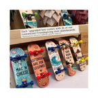 A display of mini skateboard gift boxes with colorful printed skateboards featuring custom designs and quotes, arranged on a wooden shelf with a sign explaining the customization process.
