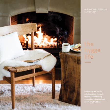 Cozy indoor scene with a fireplace, wooden bench, and table with a book and cup.
