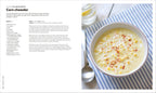 Bowl of corn chowder on a striped tablecloth with recipe text on the left.