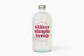 Bottle of Glitter Simple Syrup on a white background
