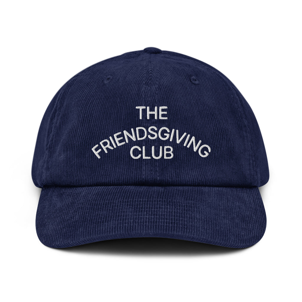 Front view of a rich navy cotton corduroy cap featuring white embroidered text that reads 'The Friendsgiving Club'.