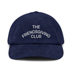 Front view of a rich navy cotton corduroy cap featuring white embroidered text that reads 'The Friendsgiving Club'.