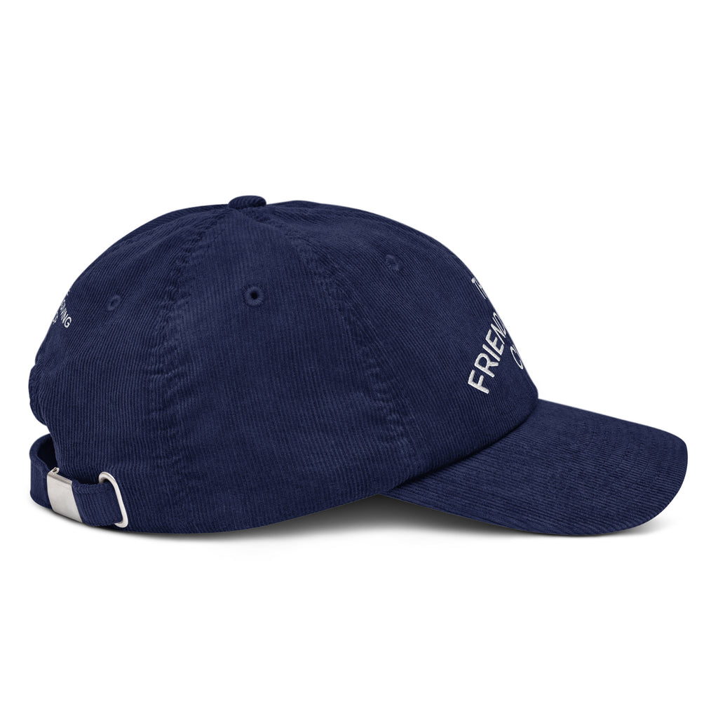 Side 1 view of a rich navy cotton corduroy cap featuring white embroidered text that reads 'The Friendsgiving Club'.