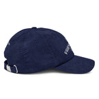Side 1 view of a rich navy cotton corduroy cap featuring white embroidered text that reads 'The Friendsgiving Club'.