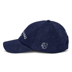 Side 2 squirrel view of a rich navy cotton corduroy cap featuring white embroidered text that reads 'The Friendsgiving Club'.